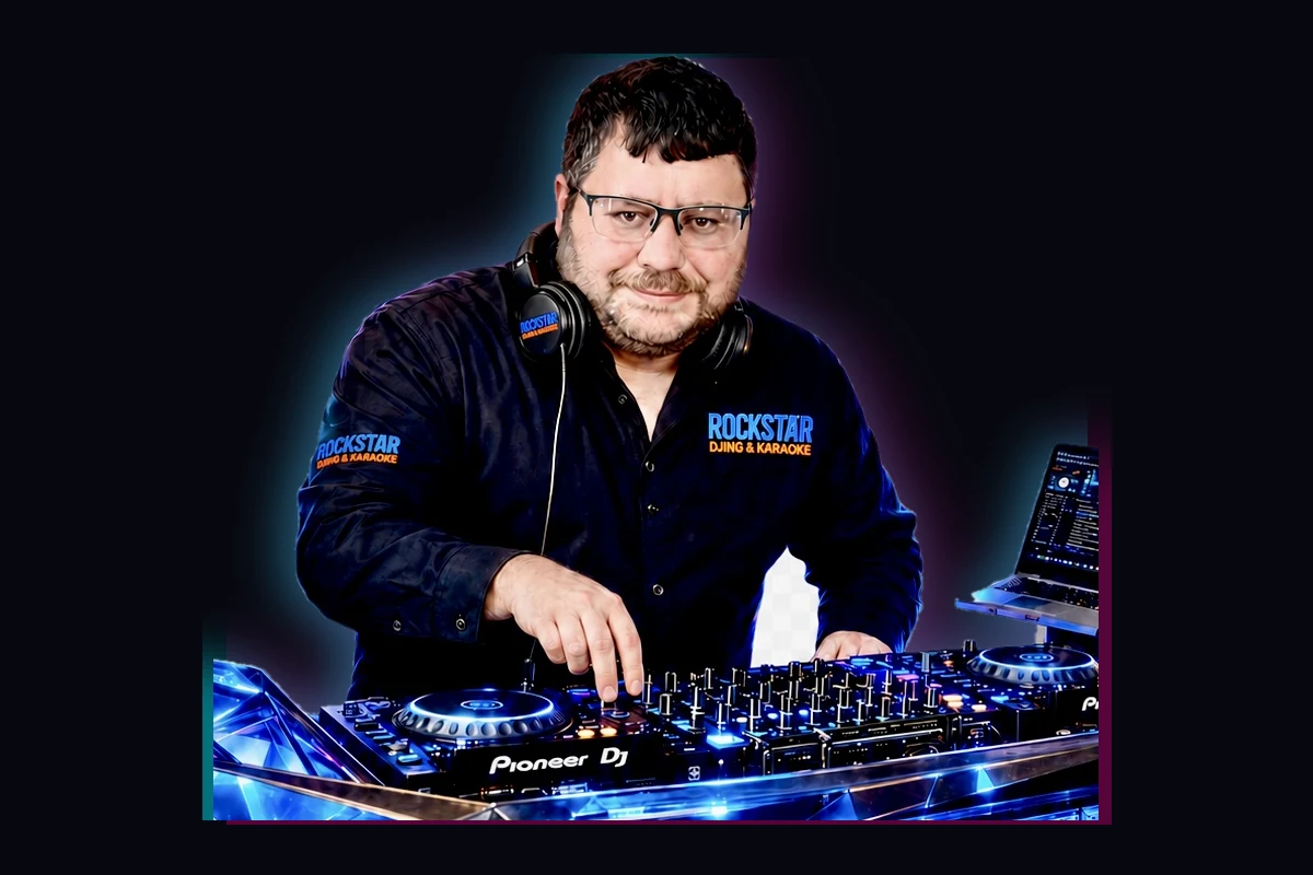 DJ Rockstar wearing branded apparel and headphones